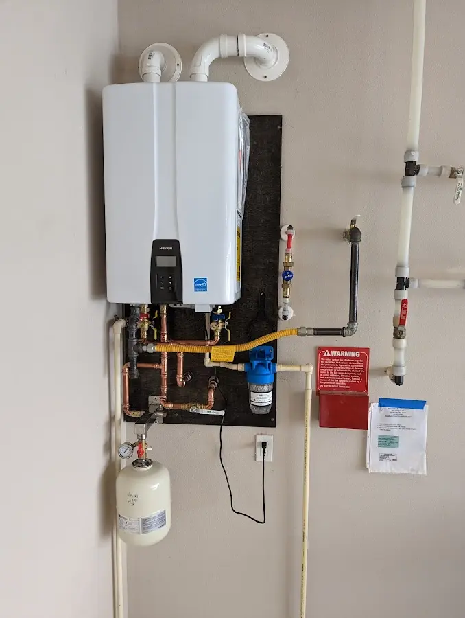 Professional plumber installing copper piping in a Oak Park Heights home